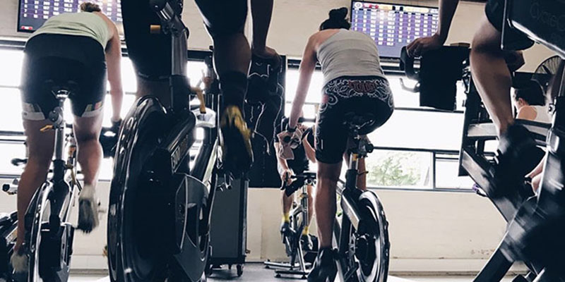 Back view of indoor cyclists